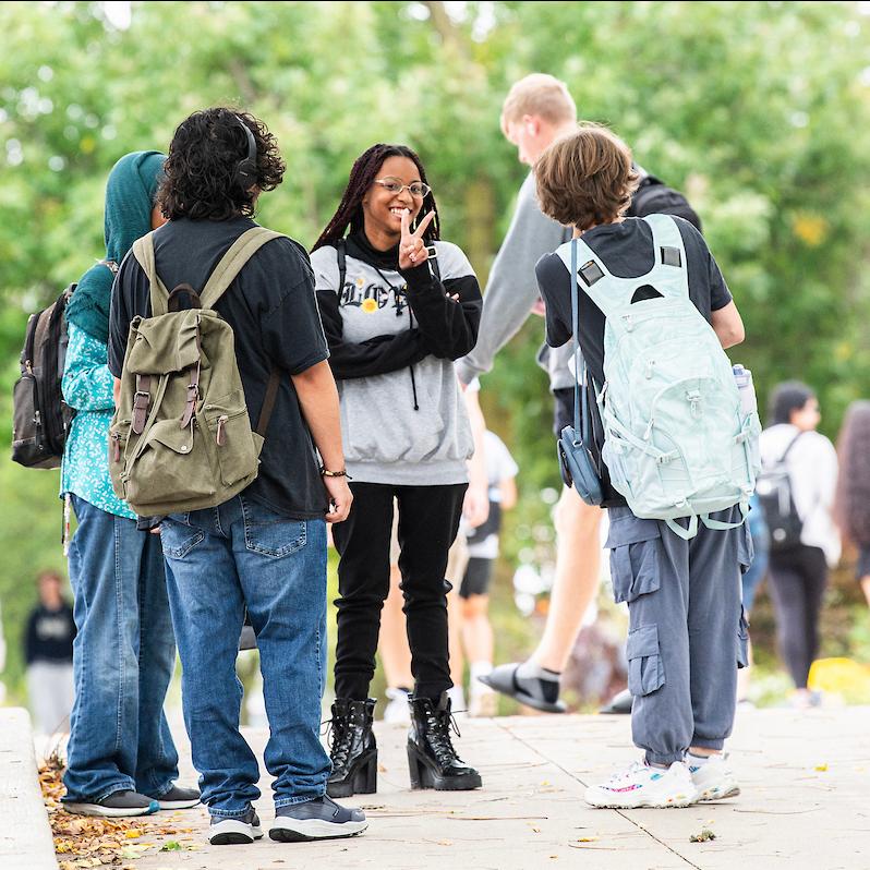 PFW students outside on campus to greet touring prospective students.