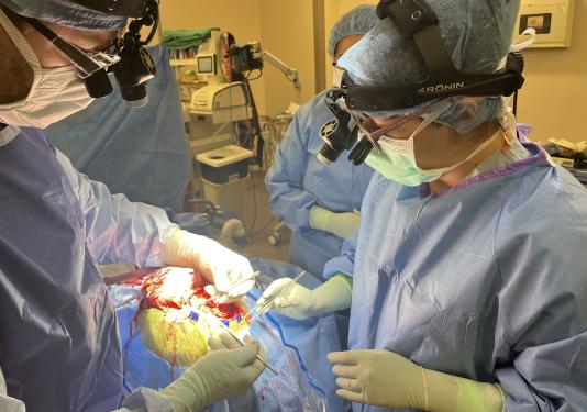 Kayla Chin is performing surgery in an operating room