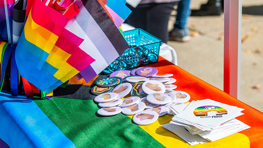 Pride giveaways on a rainbow flag background