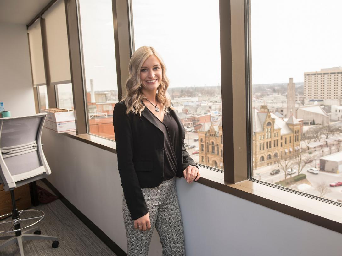 Female student posing in business setting.