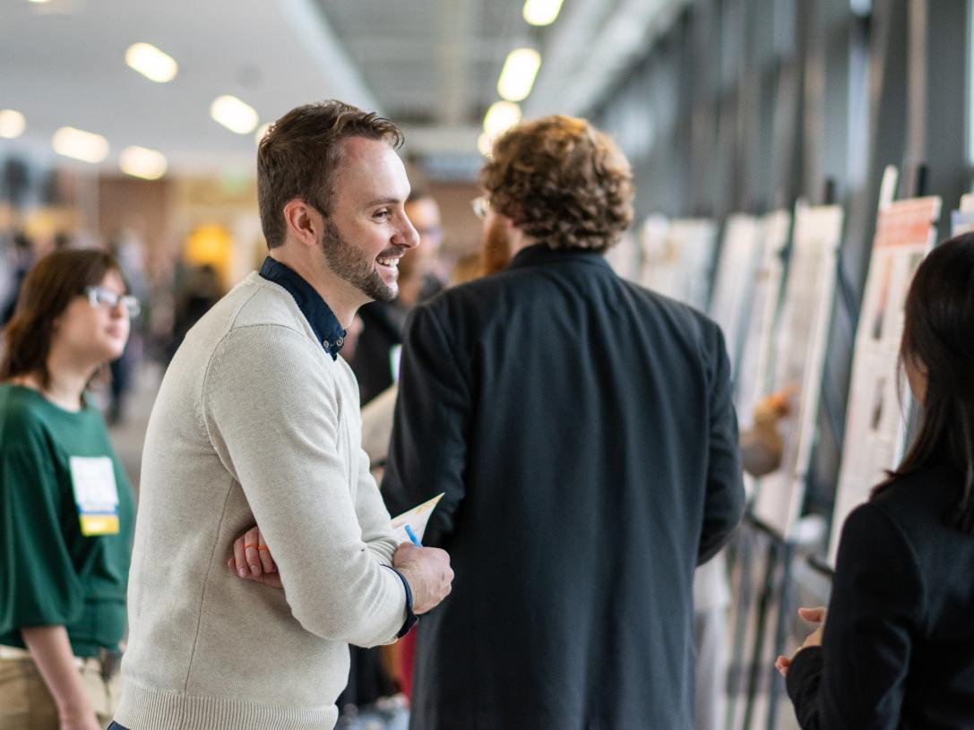 Students present projects at a research symposium.