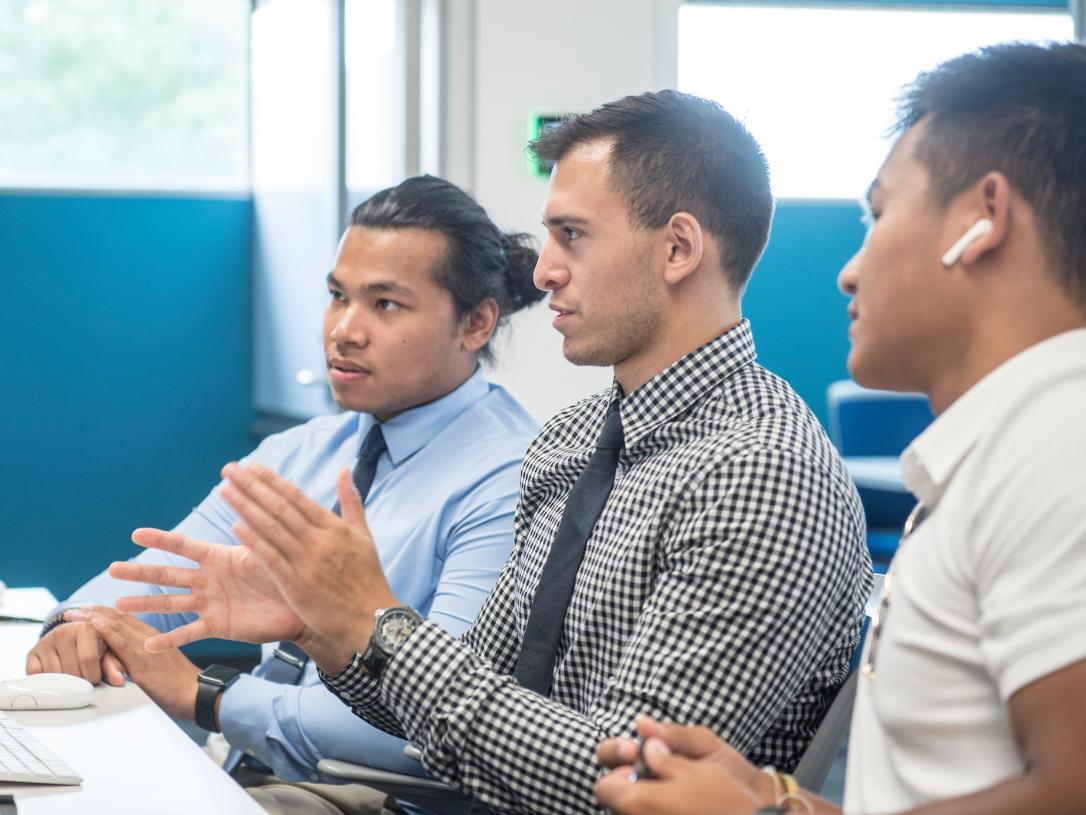 A group of male students working in the library