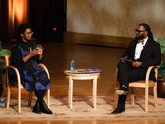 Omnibus speaker Ashley C. Ford and chief diversity officer MarTeze Hammonds chat onstage in Auer Performance Hall