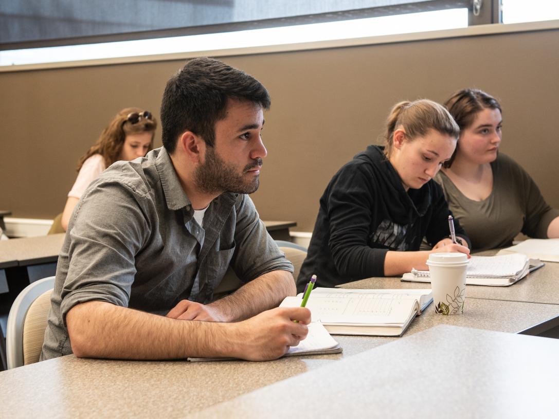 Students take notes in Arabic class.
