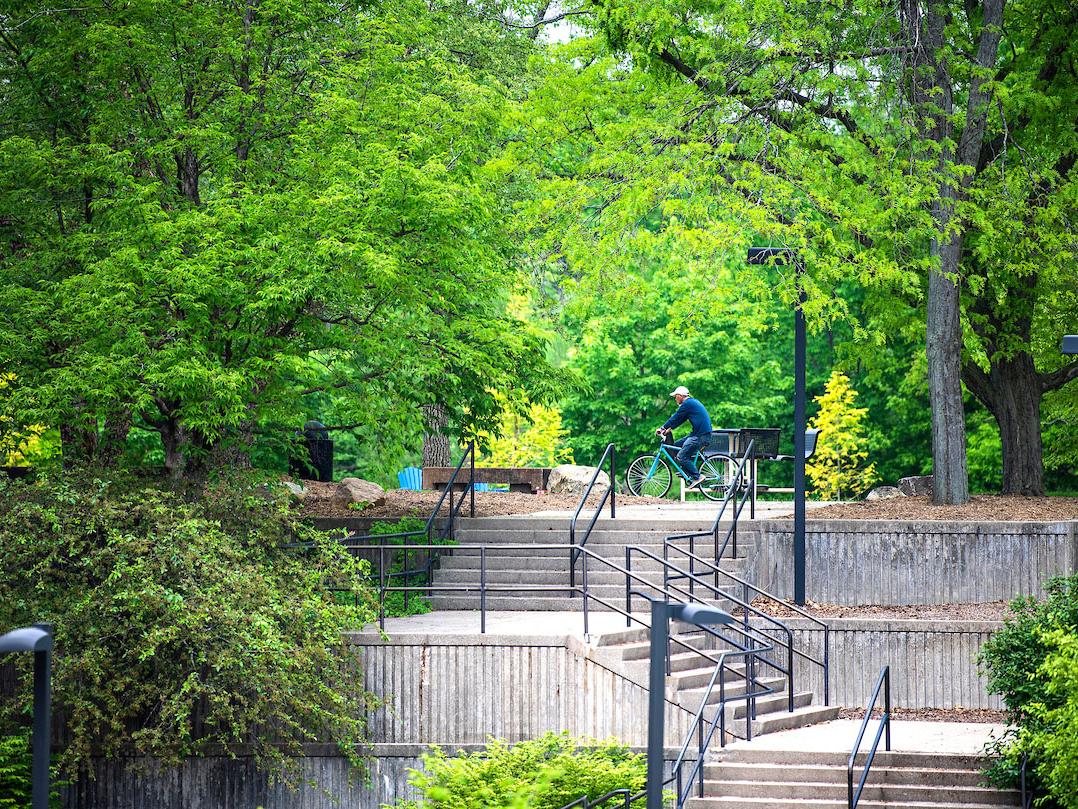 A student riding bike on campus