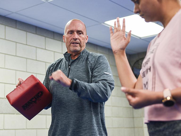 Chief Tim Potts teaches a defensive move to a RAD class participant