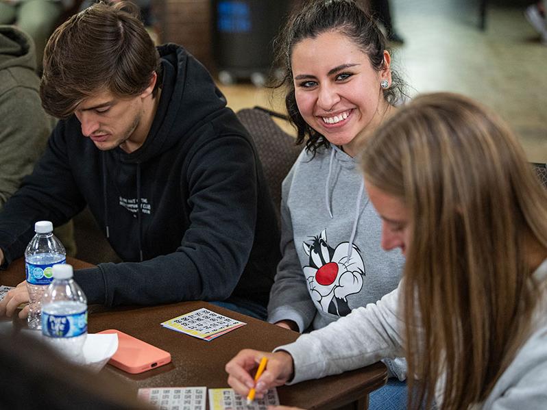 Smiling students at a bingo game