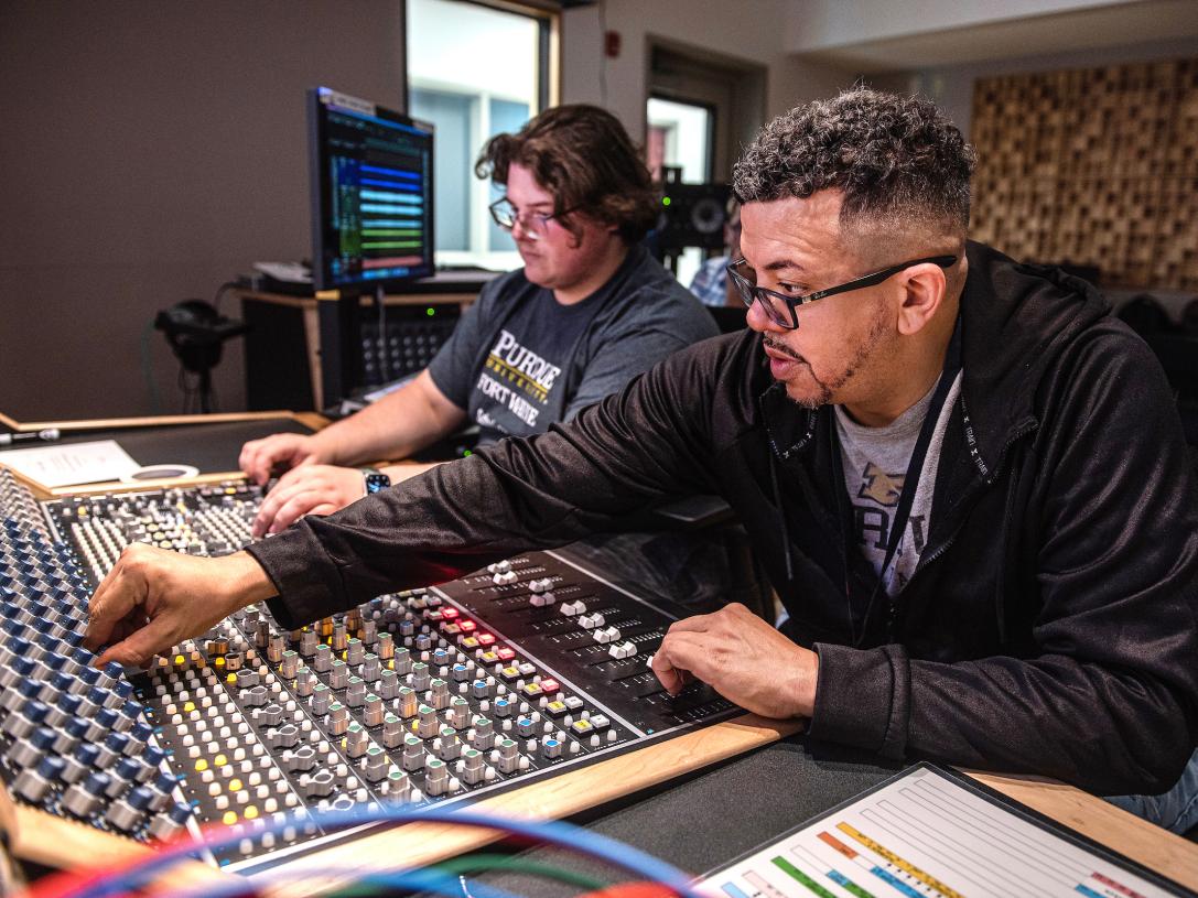 Two students working on music production in the Sweetwater center.