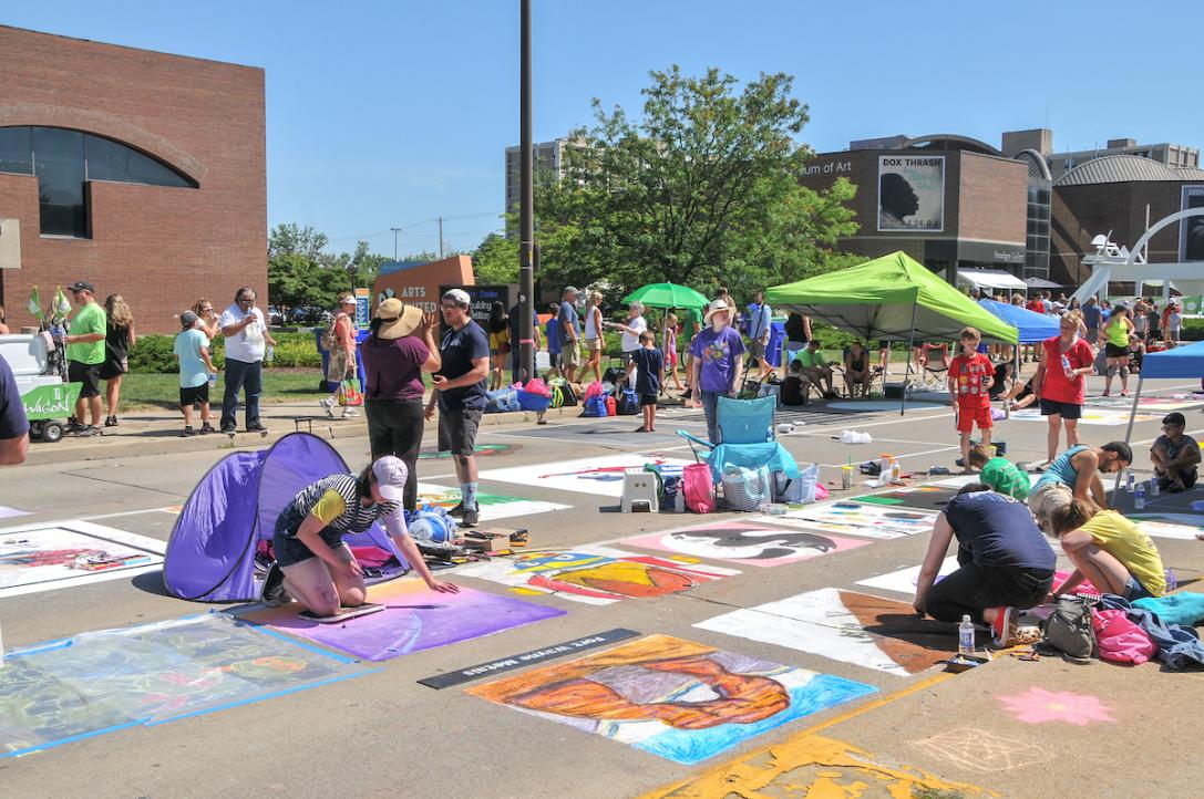 Community members draw with chalk on the streets of Fort Wayne.