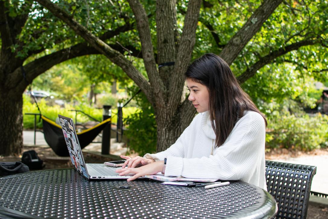 Student typing on a laptop.