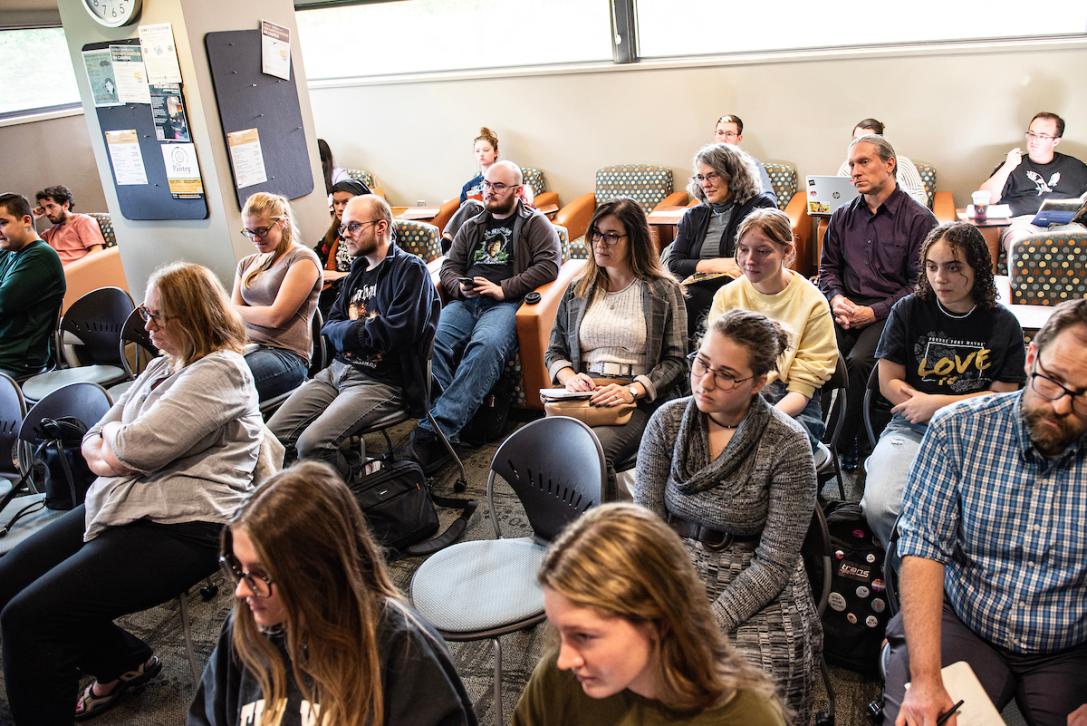 Honors students listening to a panel of speakers discuss conflict in Ukraine.