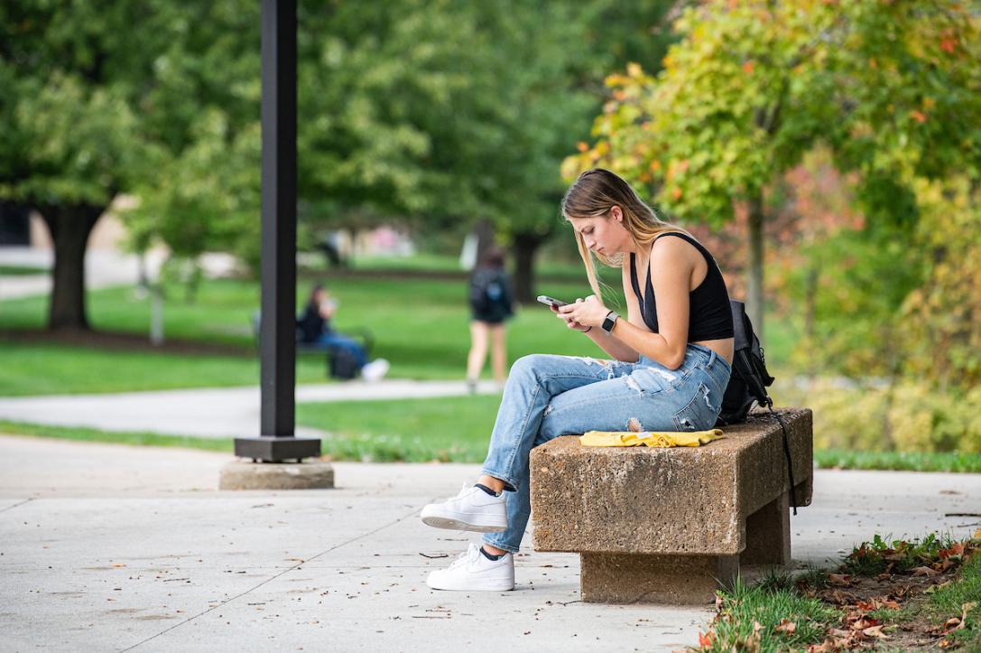 A student downloads the Rave app on their phone.