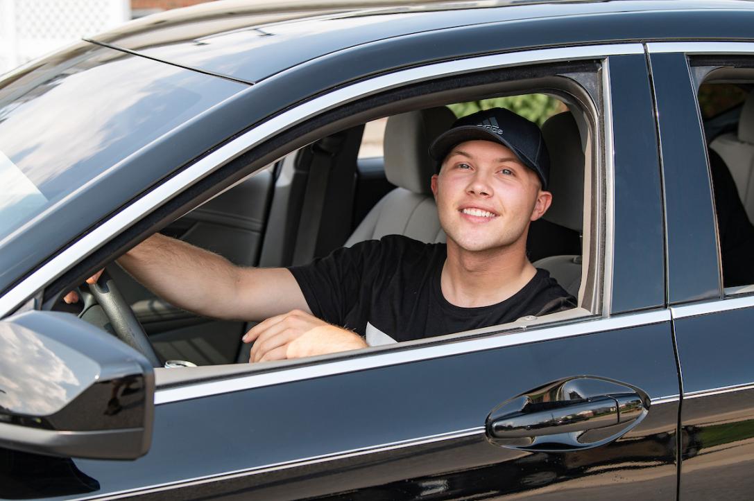 Student drives a car on campus to find a parking spot.