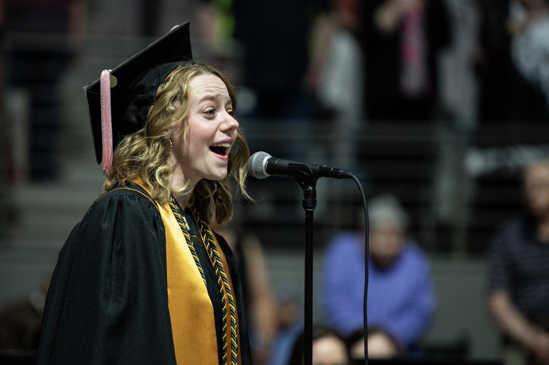 Student sings the National Anthem.