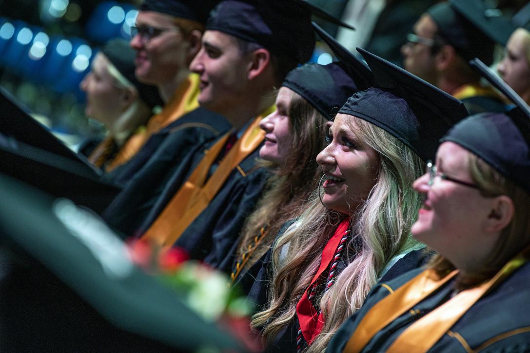 Students listen to the opening speeches of commencement.