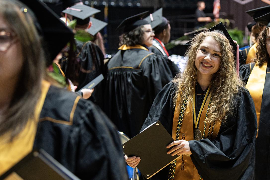 Graduating students smiling after the ceremony.