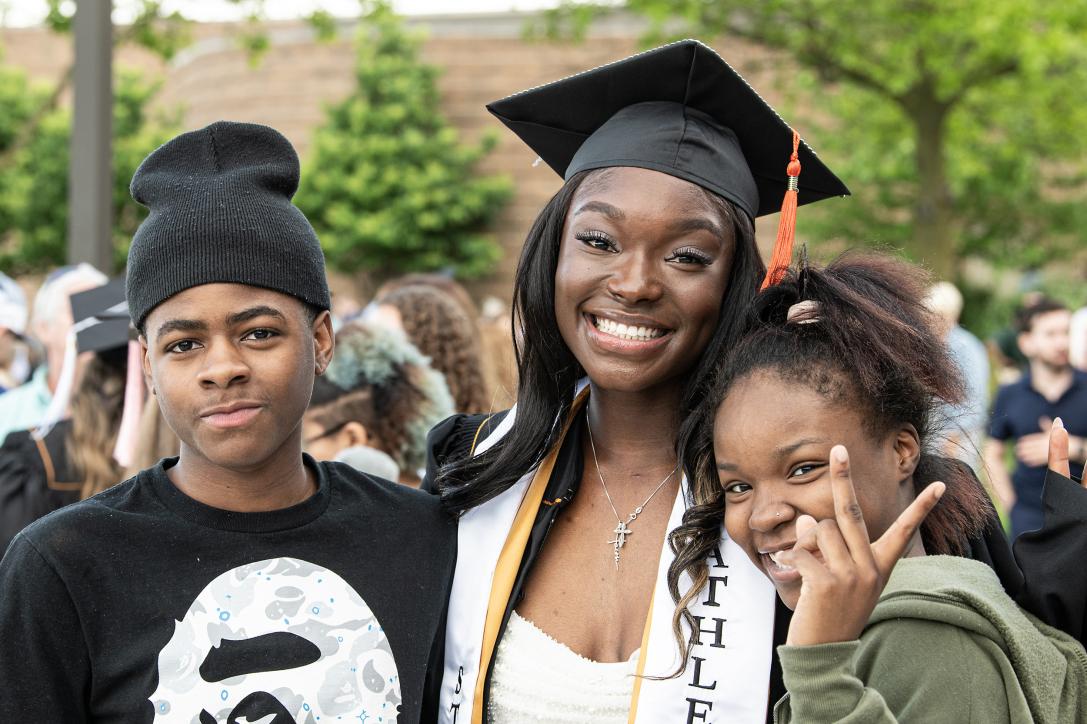 Graduated student poses with family.