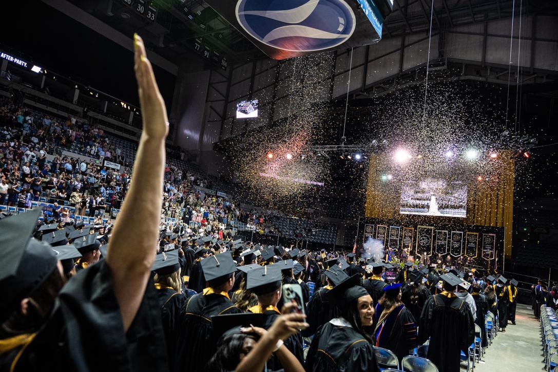 Students cheer as the confetti is released.