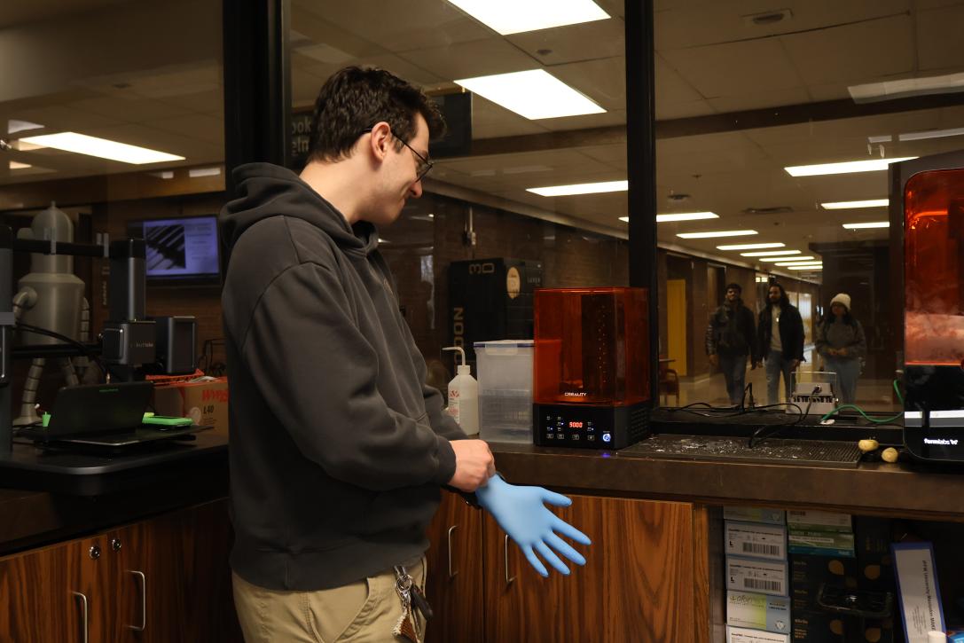 Student putting on gloves