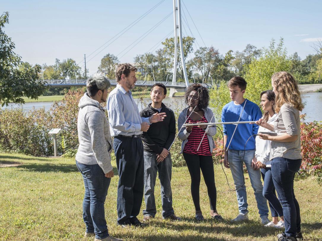 Biology professor explaining the use of an antenna in field research.