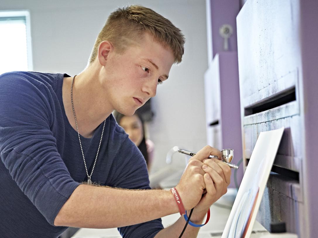 A VPA student practices airbrushing in a design lab