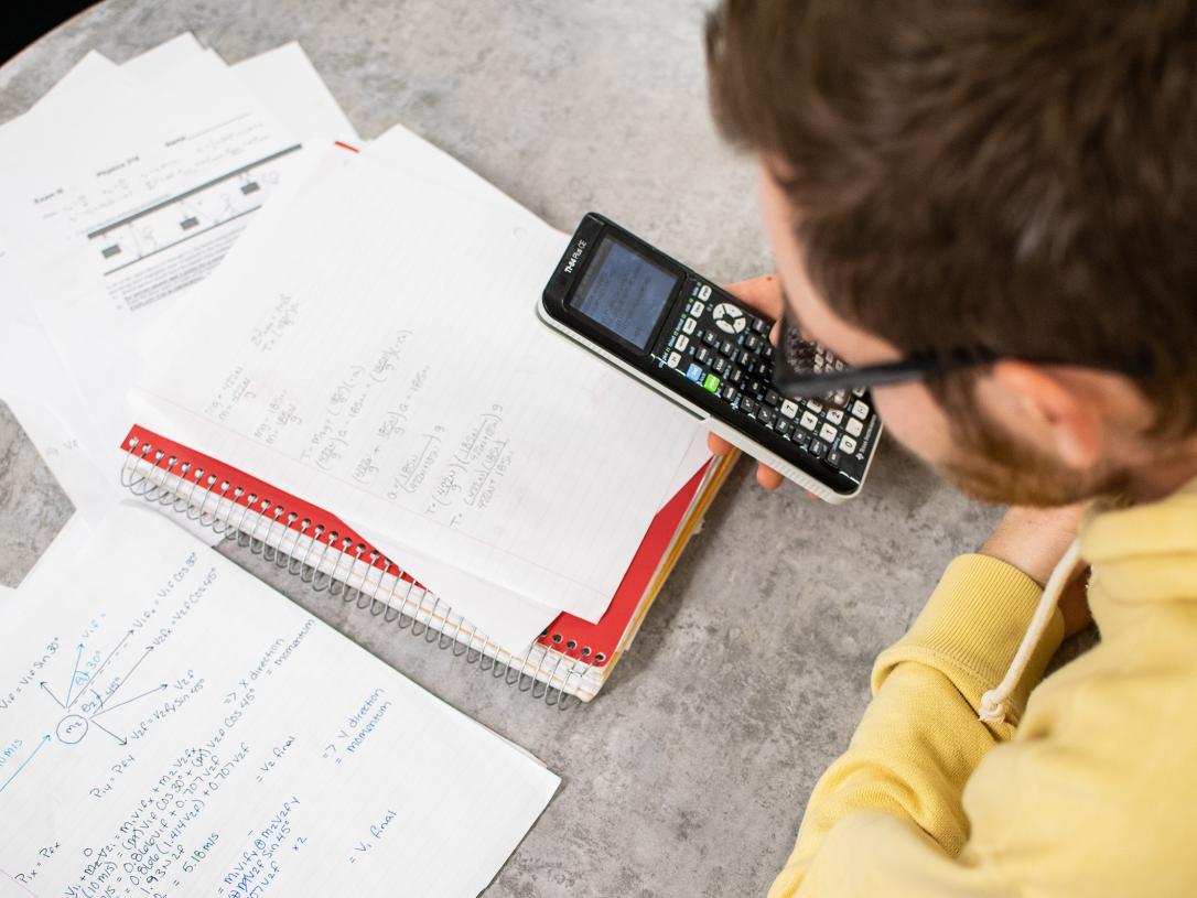 A student with a calculator