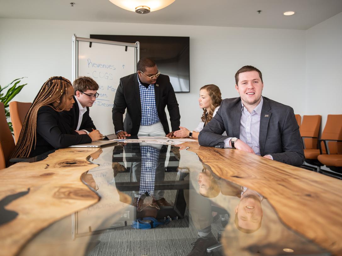 Business students at a conference table