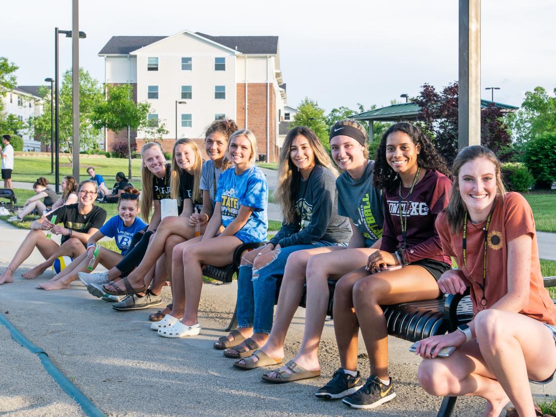 PFW students watching sand volleyball on the Student Housing campus.