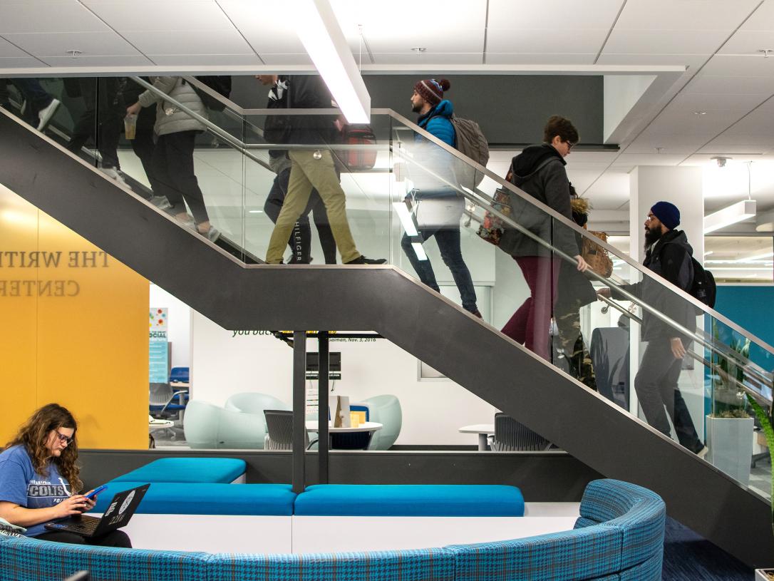 Students ascending and descending central library stairwell