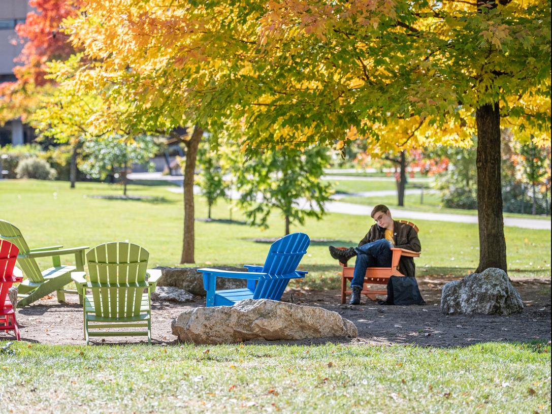 Student studying his class notes outdoors.