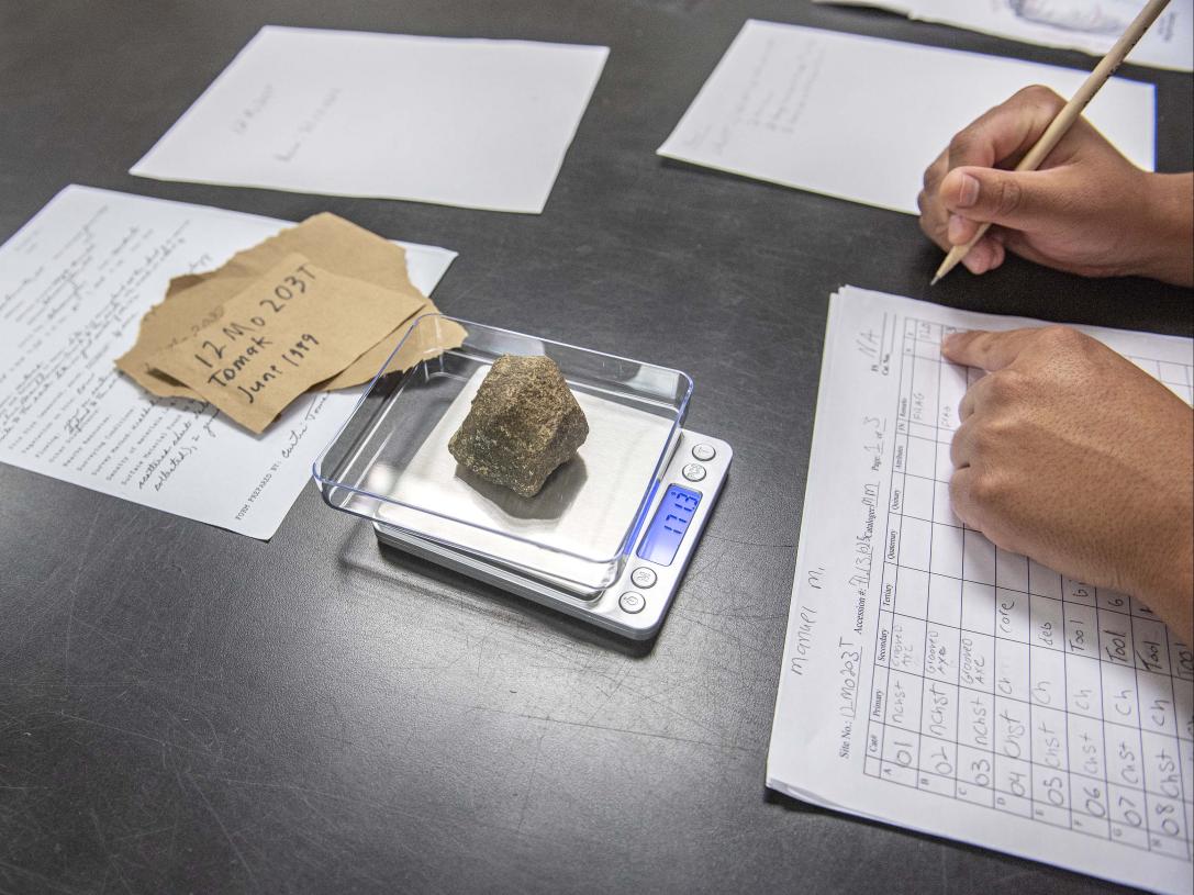 Anthropology record taking on samples in a lab setting