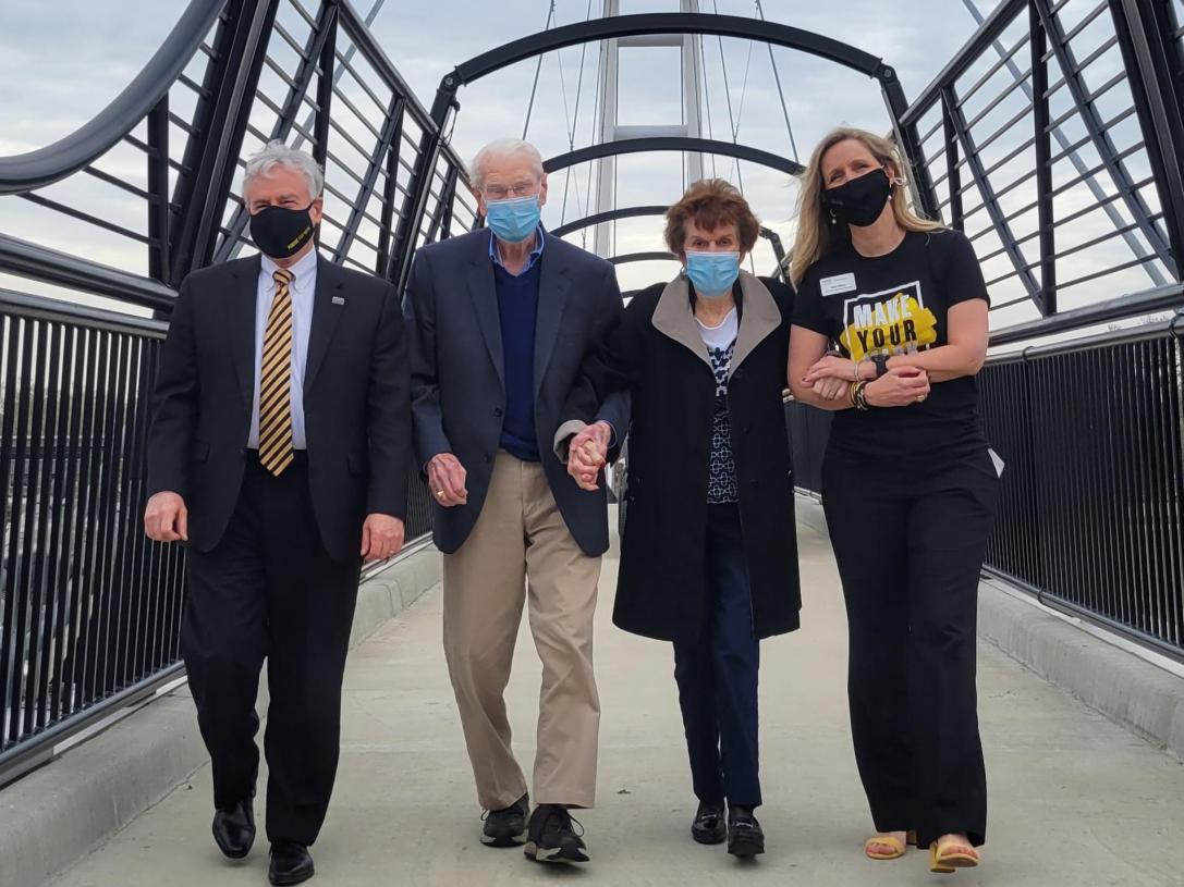 Chancellor Ron Elsenbaumer, Mac and Pat Parker, and Vice Chancellor Ruth Stone walk across the new pedestrian crossing.