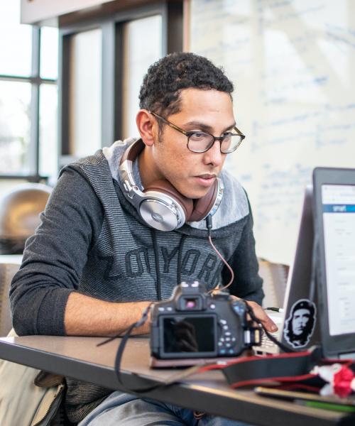 Student with headphones studying.
