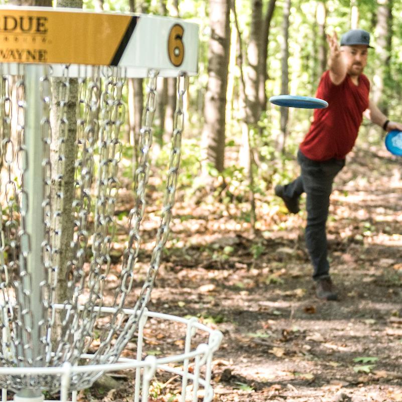 Student playing disc golf