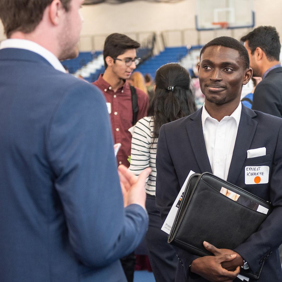 Student collecting information on careers at the career fair.