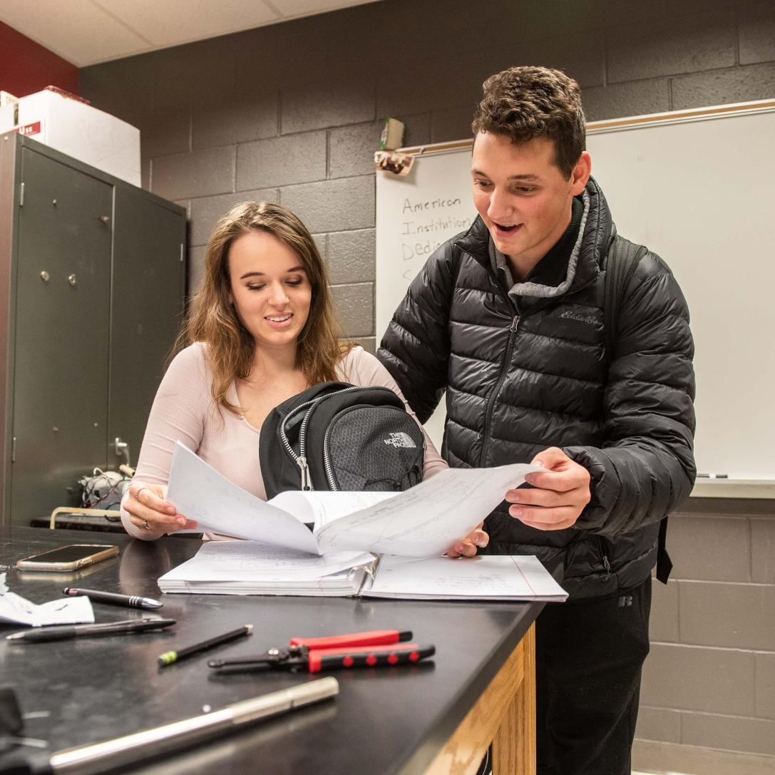 Physics students reviewing lab notes.