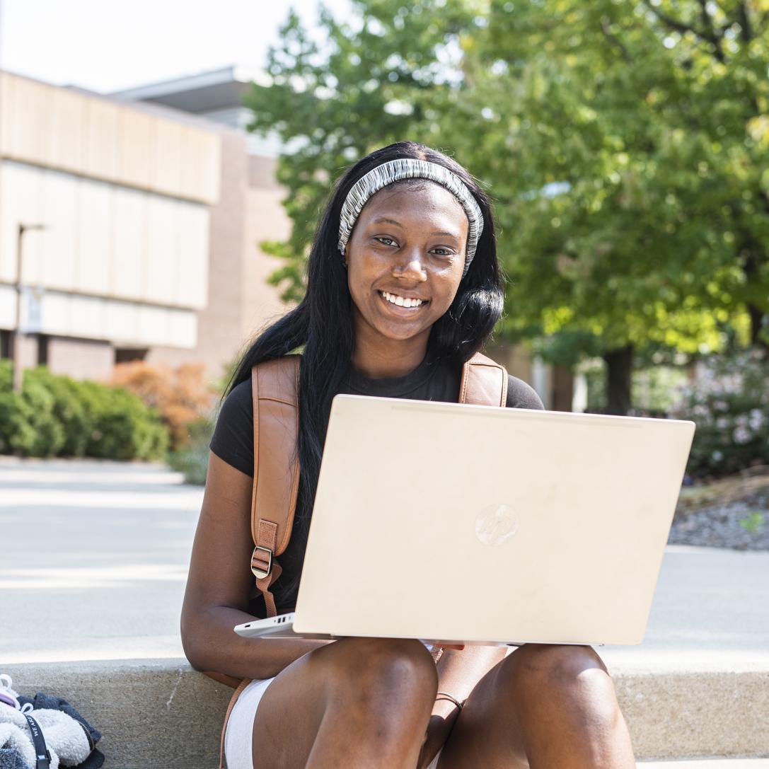 Student studying her class notes on her laptop.