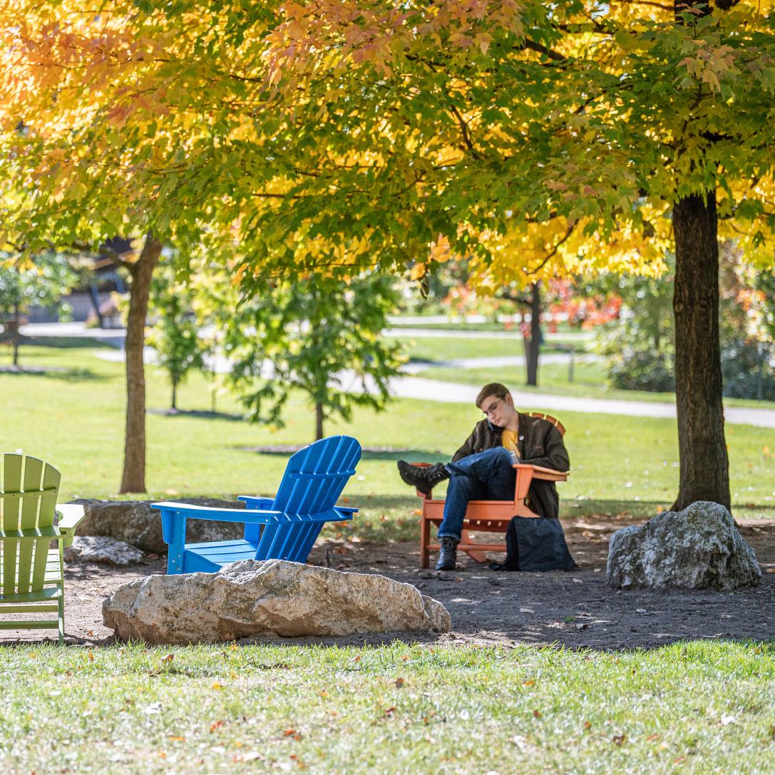 Student studying his class notes outdoors.