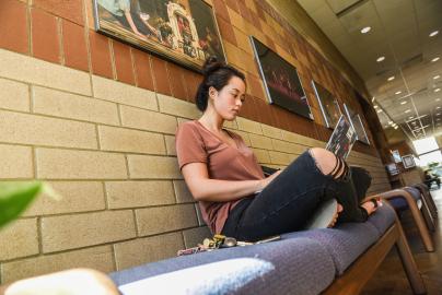 Student studying in a hallway.