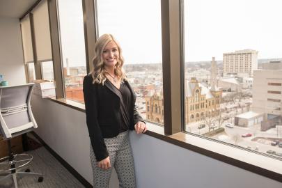 Female student posing in business setting.