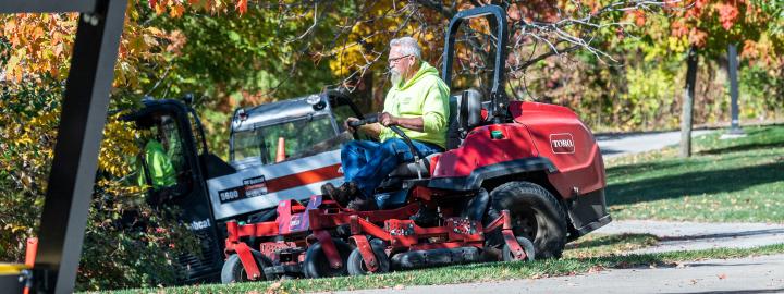 Facilities mowing campus lawn.