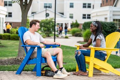 students sitting in colorful chairs