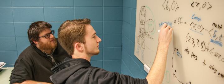 Students doing work on a whiteboard