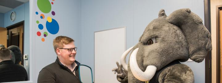 Don sits in a CSD lab with a student.