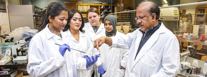 Ahmed Mustafa works with his lab assistants