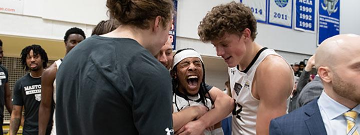 Teammates congratulate Damian Chong Qui after his game-winning shot