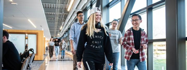 Students chat and walk across the Sky bridge.