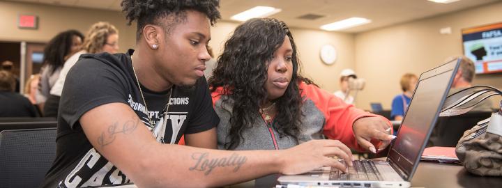 A student and parent fill out FAFSA forms at PFW.