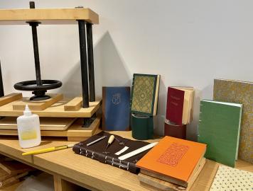 Several books of various sorts on a table with repair materials