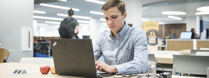 Student studying his class notes.